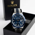 Watch with blue face and silver bracelet in a black box