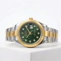 Luxury watch with green dial and gold and silver band