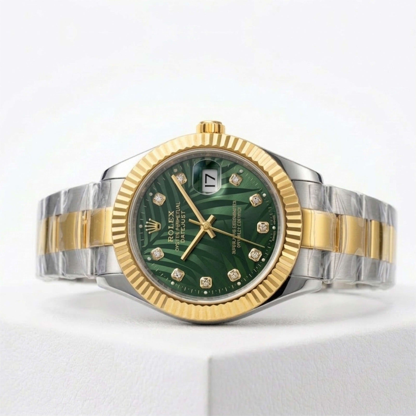 Luxury watch with green dial and gold and silver band